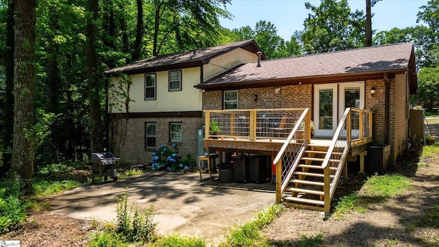 5 Nova St, Taylors, SC 29687 - rear view of property featuring brick siding, a wooden deck, a patio, stairs, and roof with shingles