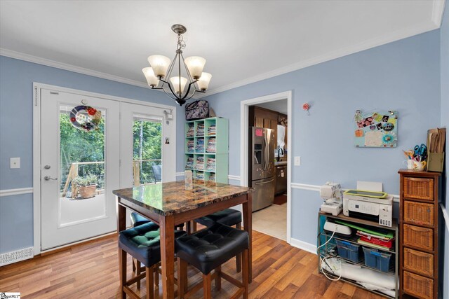 5 Nova St, Taylors, SC 29687 - dining area with a chandelier, ornamental molding, and light wood-style flooring