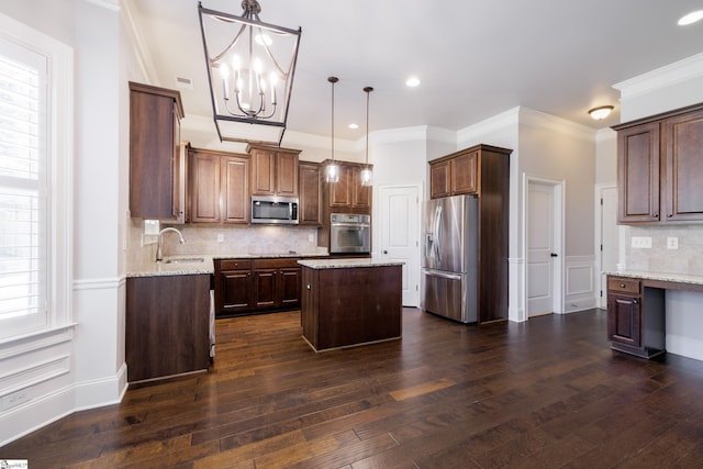 215 Wando Way, Greer, SC 29650 - kitchen featuring appliances with stainless steel finishes, a kitchen island, dark wood-type flooring, tasteful backsplash, and crown molding