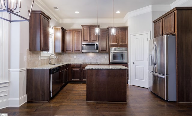 215 Wando Way, Greer, SC 29650 - kitchen with stainless steel appliances, light stone counters, a center island, dark wood-style floors, and crown molding