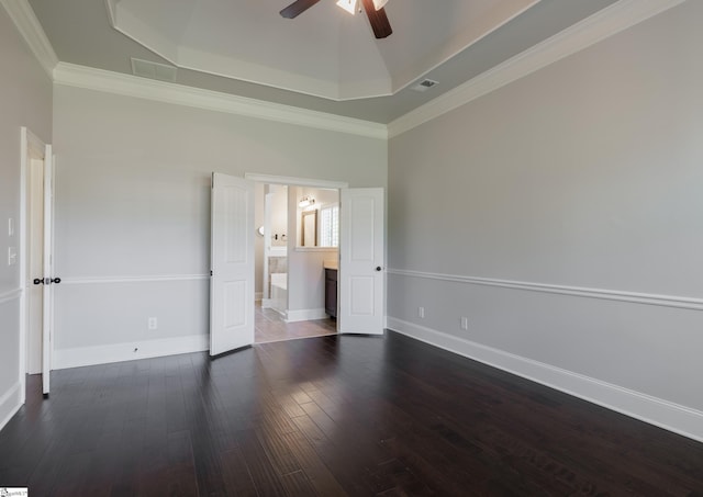 215 Wando Way, Greer, SC 29650 - unfurnished bedroom featuring a tray ceiling, dark wood finished floors, crown molding, ensuite bathroom, and ceiling fan