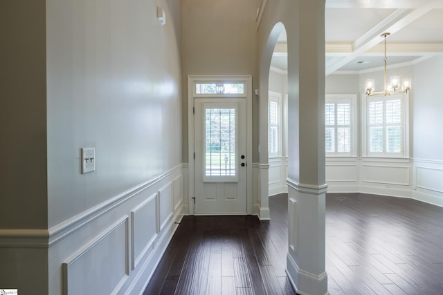 215 Wando Way, Greer, SC 29650 - foyer featuring a decorative wall, dark wood-style floors, crown molding, beam ceiling, and arched walkways
