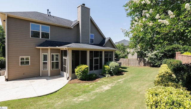 215 Wando Way, Greer, SC 29650 - rear view of house featuring a chimney, a sunroom, roof with shingles, and a patio area