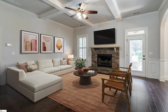 215 Wando Way, Greer, SC 29650 - living area featuring beamed ceiling, a stone fireplace, dark wood finished floors, ceiling fan, and wainscoting