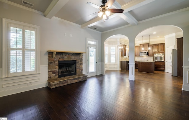 215 Wando Way, Greer, SC 29650 - unfurnished living room featuring arched walkways, beam ceiling, ceiling fan, healthy amount of natural light, and a fireplace
