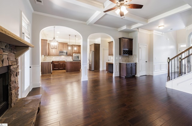 215 Wando Way, Greer, SC 29650 - unfurnished living room featuring a ceiling fan, coffered ceiling, beam ceiling, crown molding, and dark wood-type flooring