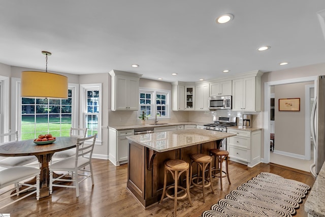 111 Brandon Way, Simpsonville, SC 29681 - kitchen featuring stainless steel appliances, a center island, a breakfast bar, backsplash, and dark wood-type flooring