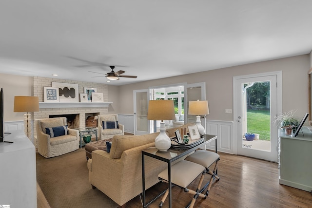 111 Brandon Way, Simpsonville, SC 29681 - living area featuring a ceiling fan, wainscoting, wood finished floors, and a brick fireplace