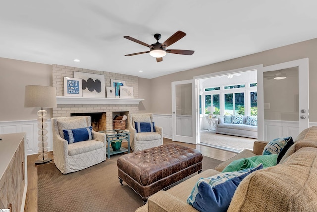 111 Brandon Way, Simpsonville, SC 29681 - living room with a decorative wall, ceiling fan, wainscoting, wood finished floors, and a fireplace