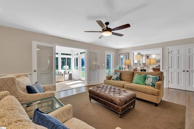 111 Brandon Way, Simpsonville, SC 29681 - living area featuring wood finished floors, a ceiling fan, a decorative wall, and a wainscoted wall