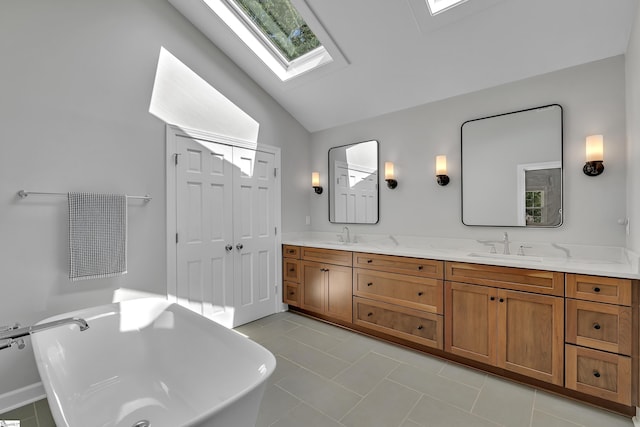 111 Brandon Way, Simpsonville, SC 29681 - bathroom featuring a skylight, lofted ceiling, double vanity, a freestanding tub, and tile patterned flooring