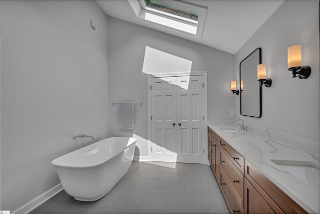 111 Brandon Way, Simpsonville, SC 29681 - bathroom with a skylight, a freestanding tub, double vanity, tile patterned flooring, and vaulted ceiling