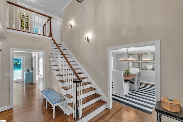 111 Brandon Way, Simpsonville, SC 29681 - staircase featuring wood finished floors, a chandelier, ornamental molding, and a towering ceiling