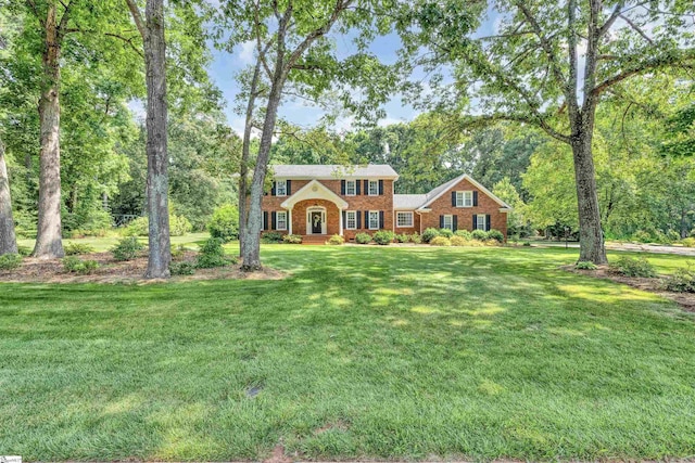 111 Brandon Way, Simpsonville, SC 29681 - colonial home featuring a front lawn, brick siding, and view of scattered trees