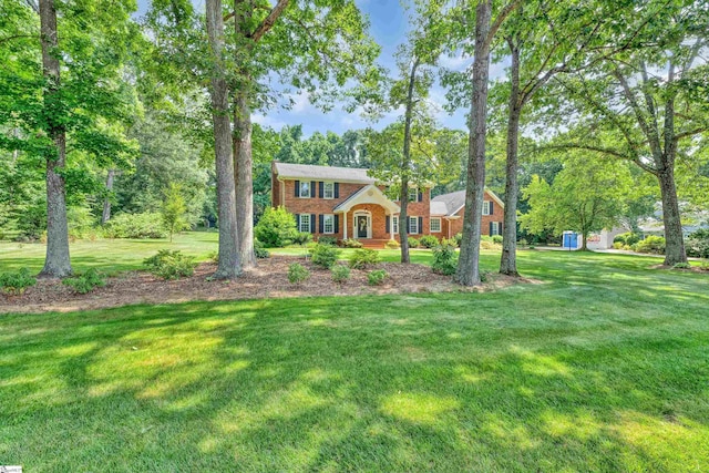 111 Brandon Way, Simpsonville, SC 29681 - colonial house featuring a front yard, brick siding, and view of wooded area
