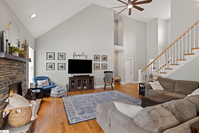 6 Mandarin Cir, Taylors, SC 29687 - living room with high vaulted ceiling, a ceiling fan, stairway, a stone fireplace, and wood finished floors