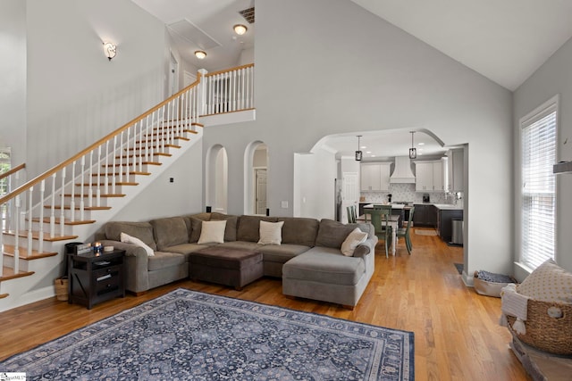 6 Mandarin Cir, Taylors, SC 29687 - living room with high vaulted ceiling, arched walkways, light wood finished floors, and stairs