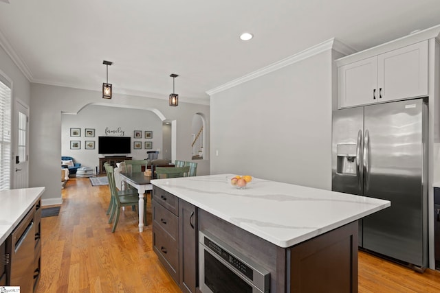 6 Mandarin Cir, Taylors, SC 29687 - kitchen featuring stainless steel fridge, arched walkways, ornamental molding, hanging light fixtures, and dark brown cabinetry