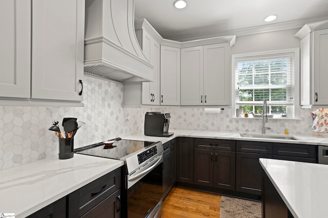 6 Mandarin Cir, Taylors, SC 29687 - kitchen featuring stainless steel range with electric cooktop, wall chimney exhaust hood, light stone counters, white cabinets, and recessed lighting