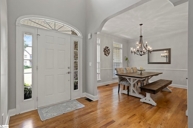 6 Mandarin Cir, Taylors, SC 29687 - foyer entrance featuring arched walkways, light wood finished floors, crown molding, and a chandelier