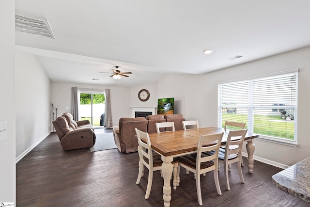 259 Millen Dr, Woodruff, SC 29388 - dining space with dark wood-type flooring, a fireplace, and a ceiling fan