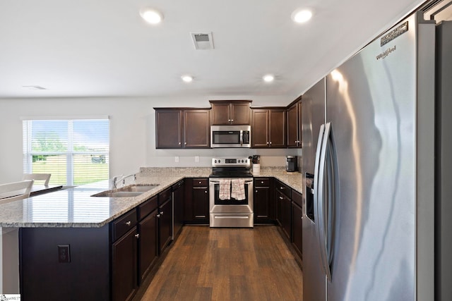 259 Millen Dr, Woodruff, SC 29388 - kitchen featuring stainless steel appliances, dark wood-style flooring, dark brown cabinets, a peninsula, and recessed lighting