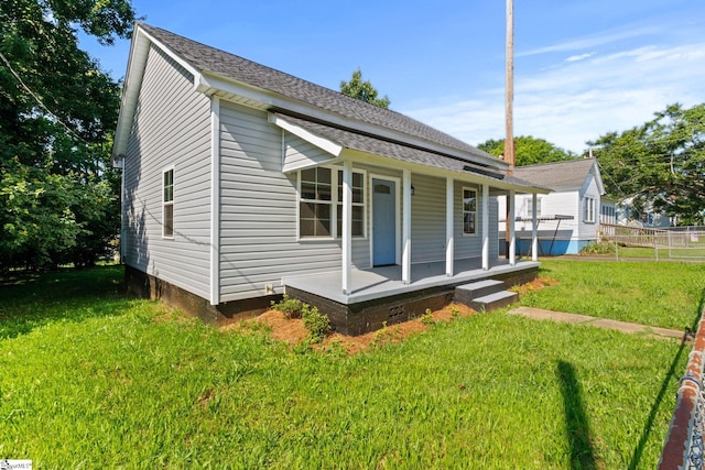 1231 Apalache St, Greer, SC 29651 - back of house featuring a porch, a lawn, and a shingled roof