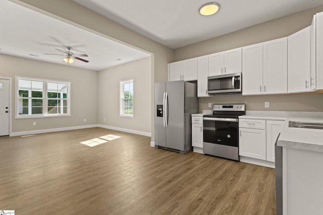 1231 Apalache St, Greer, SC 29651 - kitchen featuring stainless steel appliances, light countertops, white cabinets, and light wood-style floors