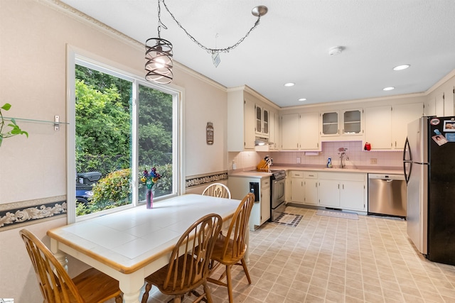 217 Devenger Rd, Greer, SC 29650 - kitchen featuring stainless steel appliances, light countertops, decorative backsplash, recessed lighting, and glass insert cabinets