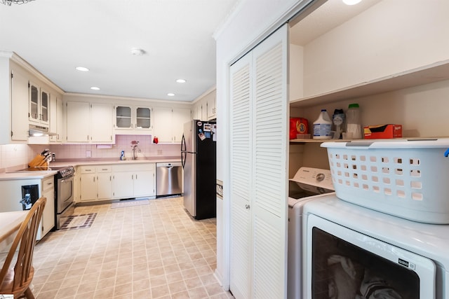 217 Devenger Rd, Greer, SC 29650 - kitchen featuring stainless steel appliances, washer / dryer, under cabinet range hood, light countertops, and tasteful backsplash