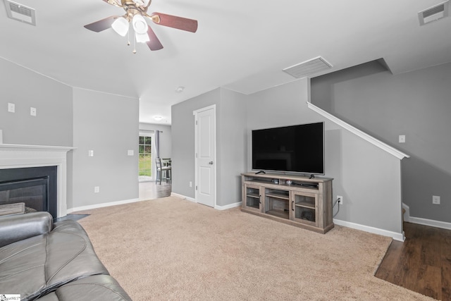 626 Duncan Station Dr, Duncan, SC 29334 - carpeted living area featuring ceiling fan, a fireplace with flush hearth, and stairs