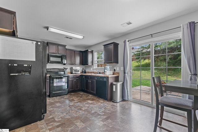 626 Duncan Station Dr, Duncan, SC 29334 - kitchen featuring black appliances, light countertops, and dark brown cabinets