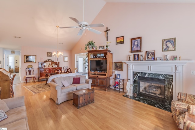 110 Baldwin Pl, Easley, SC 29642 - living area featuring light wood-style flooring, a ceiling fan, a chandelier, high vaulted ceiling, and a high end fireplace