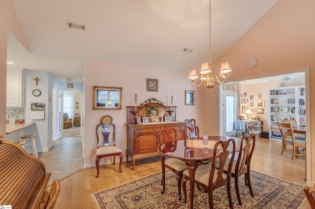 110 Baldwin Pl, Easley, SC 29642 - dining room with high vaulted ceiling, a chandelier, light wood-style flooring, and a ceiling fan