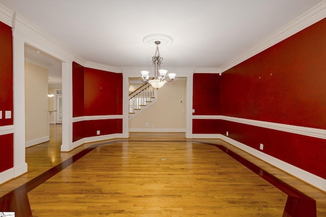 3 Henson Pl, Greer, SC 29650 - unfurnished dining area with a chandelier, wood finished floors, crown molding, and stairs