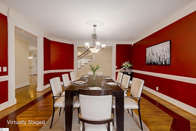 3 Henson Pl, Greer, SC 29650 - dining area with a chandelier, wood finished floors, ornamental molding, and stairs