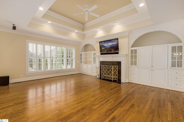3 Henson Pl, Greer, SC 29650 - unfurnished living room featuring a high end fireplace, ceiling fan, wood finished floors, ornamental molding, and a tray ceiling