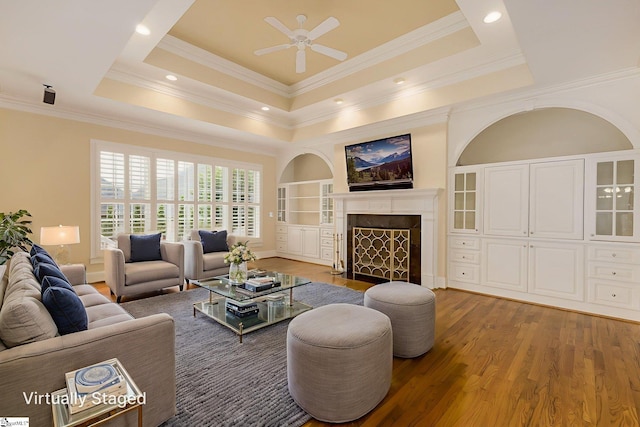3 Henson Pl, Greer, SC 29650 - living room featuring ceiling fan, wood finished floors, a fireplace, ornamental molding, and a raised ceiling