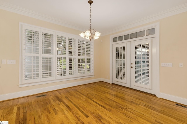 3 Henson Pl, Greer, SC 29650 - empty room featuring ornamental molding, a chandelier, french doors, and wood finished floors