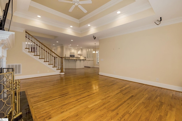3 Henson Pl, Greer, SC 29650 - unfurnished living room featuring wood finished floors, ornamental molding, a ceiling fan, recessed lighting, and stairs