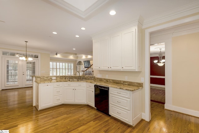 3 Henson Pl, Greer, SC 29650 - kitchen with black dishwasher, a chandelier, light wood-type flooring, crown molding, and white cabinets