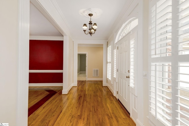 3 Henson Pl, Greer, SC 29650 - entryway featuring a chandelier, light wood-style flooring, and crown molding