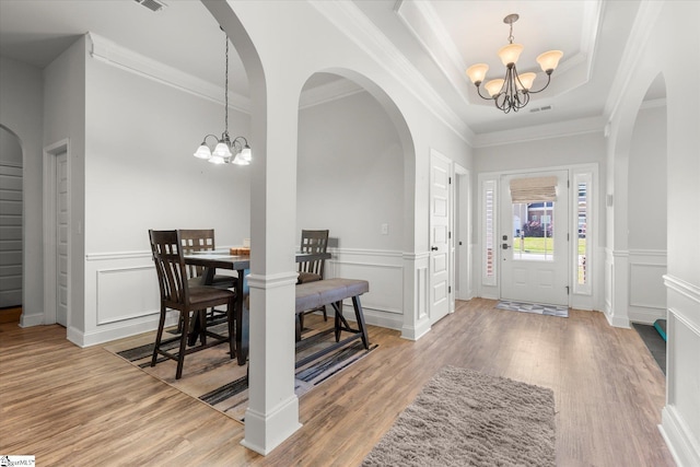 505 E Czardas Way, Woodruff, SC 29375 - foyer entrance with a chandelier, wood finished floors, a decorative wall, arched walkways, and crown molding