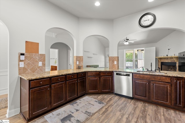 505 E Czardas Way, Woodruff, SC 29375 - kitchen featuring dishwasher, ceiling fan, a fireplace, light stone countertops, and decorative backsplash