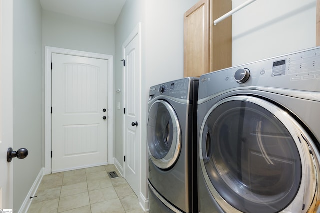 101 Stonewash Way, Greer, SC 29650 - laundry area featuring cabinet space, washer and clothes dryer, and light tile patterned floors
