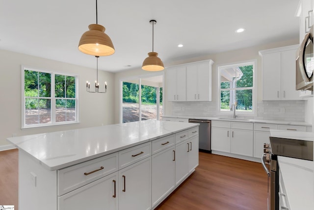 293 Pine Hills Rd, Woodruff, SC 29388 - kitchen with stainless steel appliances, backsplash, wood finished floors, white cabinets, and recessed lighting