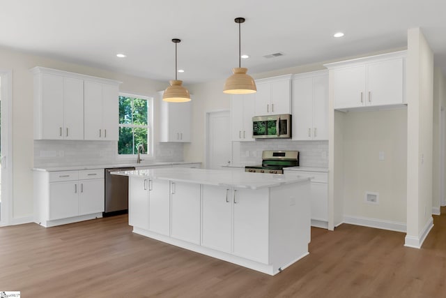 293 Pine Hills Rd, Woodruff, SC 29388 - kitchen featuring stainless steel appliances, a center island, white cabinets, and recessed lighting