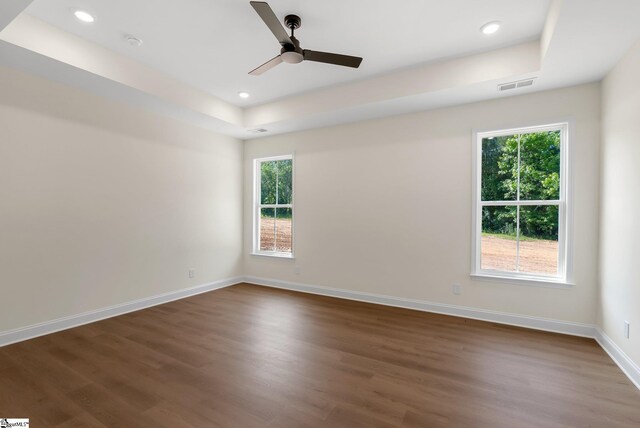 293 Pine Hills Rd, Woodruff, SC 29388 - unfurnished room with plenty of natural light, dark wood-type flooring, ceiling fan, recessed lighting, and a tray ceiling