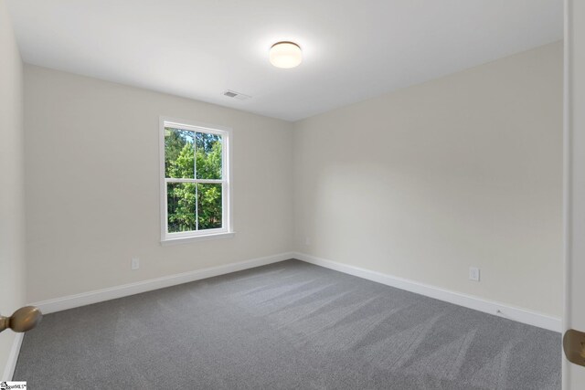 293 Pine Hills Rd, Woodruff, SC 29388 - unfurnished room featuring dark colored carpet and baseboards