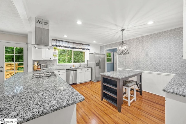 111 Bonwood Ave, Simpsonville, SC 29681 - kitchen with stainless steel appliances, island range hood, white cabinetry, ornamental molding, and light wood-type flooring